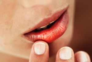 getty_rf_photo_of_woman_touching_chapped_lips